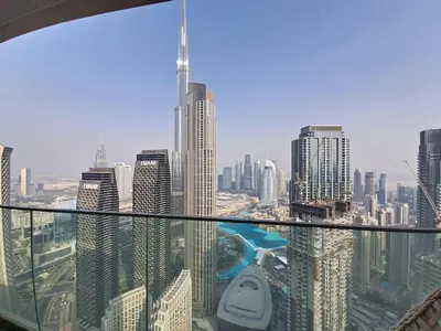 a view of a city from the top of a skyscraper at Locations I Downtown Dubai I Premium 3BR Apartment I Luxury & Modern Interiors I Stunning Burj Khalifa Views I Steps from Dubai Mall & Dubai Fountain in Dubai
