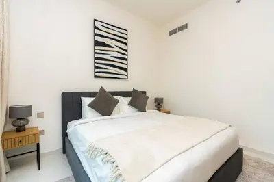 a bedroom with a large bed with white sheets and pillows at CitiHome Luxury Stay Panoramic Sea Views 2BR in Dubai