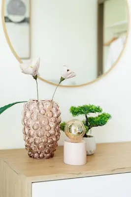a vase on a table with a mirror and plants at CitiHome Luxury Stay Panoramic Sea Views 2BR in Dubai
