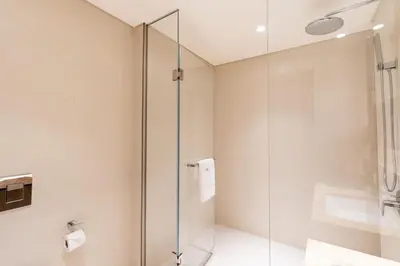 a bathroom with a glass shower and a sink at CitiHome Luxury Stay Panoramic Sea Views 2BR in Dubai