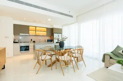 a kitchen and dining room with a glass table and chairs at CitiHome Luxury Stay Panoramic Sea Views 2BR in Dubai