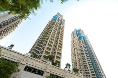 two tall buildings standing next to each other at Skyline 43 - Penthouse Burj Khalifa View & Pool in Dubai