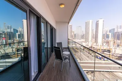 an apartment balcony with a view of a city at 1BR with Burj Khalifa view in Business Bay in Dubai