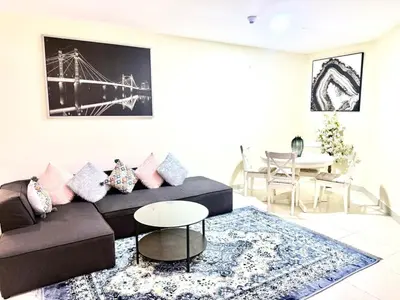 a living room with a couch and a table at Dubai gate 1 in Dubai
