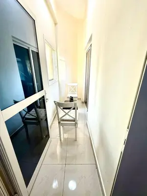 a hallway with a chair and a table at Dubai gate 1 in Dubai