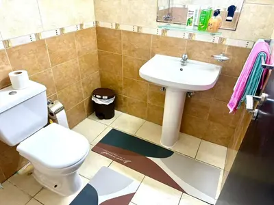 a bathroom with a toilet and a sink at Dubai gate 1 in Dubai