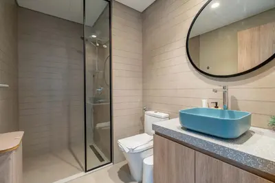 a bathroom with a sink and a toilet and a mirror at Waterfront 1BR with Canal Views in Peninsula One in Dubai