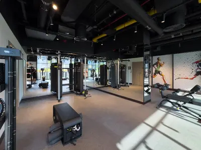 a gym with several treadmills and cardio equipment at Waterfront 1BR with Canal Views in Peninsula One in Dubai