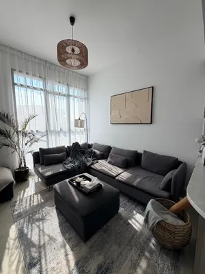 a living room with a couch and a table at Modern apartment Dubai in Dubai