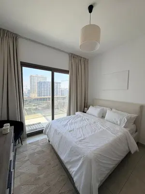 a bedroom with a white bed and a large window at Modern apartment Dubai in Dubai