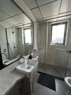 a bathroom with a sink and a shower and a mirror at Modern apartment Dubai in Dubai