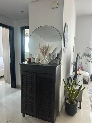 a mirror on top of a dresser in a room at Modern apartment Dubai in Dubai
