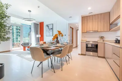 a kitchen and dining room with a table and chairs at Balcony with Panoramic Dubai Water Canal and City Views, Walking Distance to Metro and Marine Transport, Urban Oasis, Business Bay by Deluxe Holiday Homes in Dubai