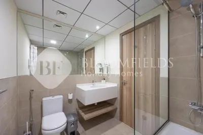 a bathroom with a white toilet and a sink at Bloomfields Canal View 2Br Apt Canal Business in Dubai