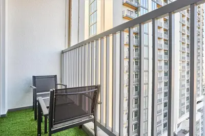 two benches on the balcony of a building at STAY BY LATINEM Luxury 1BR Holiday Home CC 2913 Near Burj Khalifa in Dubai