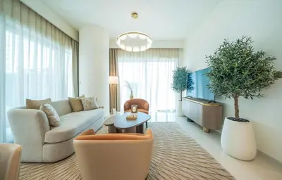 a living room with a couch and a table at Zapbed House -Elegant 1 BR Apartment Grand Bleu Emaar Beachfront in Dubai