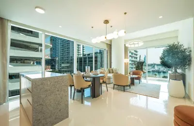 a dining room with a table and chairs at Zapbed House -Elegant 1 BR Apartment Grand Bleu Emaar Beachfront in Dubai