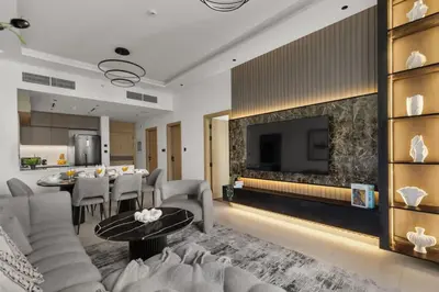 a living room with a couch and a fireplace at Stylish 2 Bedrooms, Pool, Gym & Family-Friendly in Dubai