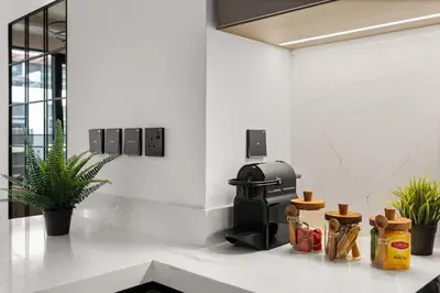 a kitchen with a coffee maker and plants on a counter at Stylish 2 Bedrooms, Pool, Gym & Family-Friendly in Dubai