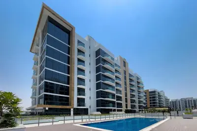 a large apartment building with a swimming pool at Stylish Studio in Nad Al Sheba in Dubai