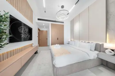 a bedroom with a large bed and a tv at Chic 1BR Getaway, Sleeps 4, Stunning Pool Views in Dubai