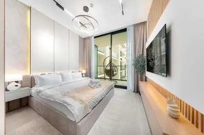 a bedroom with a large bed and a large window at Chic 1BR Getaway, Sleeps 4, Stunning Pool Views in Dubai
