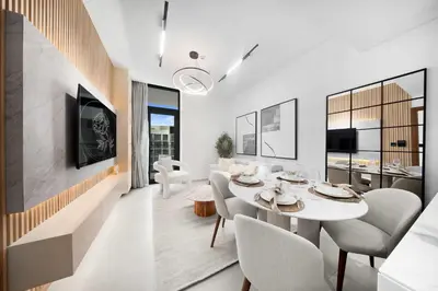 a dining room with a white table and chairs at Chic 1BR Getaway, Sleeps 4, Stunning Pool Views in Dubai