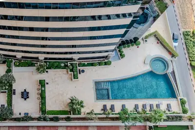 an aerial view of a hotel with a swimming pool at TRPS - Elite Residence, Dubai Marina - Modern High-Rise, Near Popular Sites, Partial Sea View in Dubai