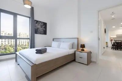 a bedroom with a bed with a suitcase on it at 2BR in Safi Balcony Walk to Town Sq Park in Dubai