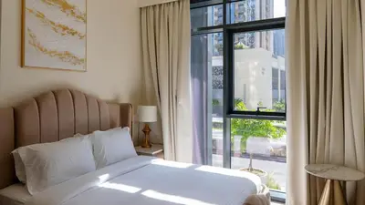 a bedroom with a bed and a large window at Luxury 2BR unit with speculator full road view in Dubai