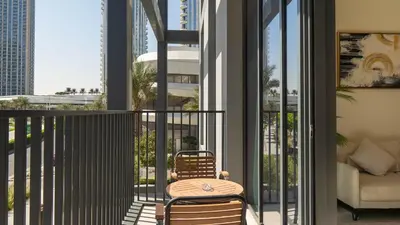 a patio with a table and chairs on a balcony at Luxury 2BR unit with speculator full road view in Dubai