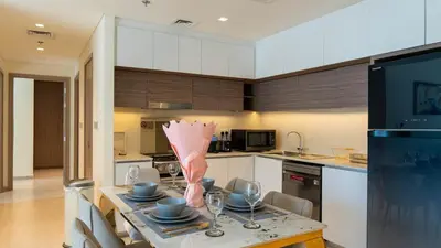 a kitchen with a table with a vase on it at Luxury 2BR unit with speculator full road view in Dubai