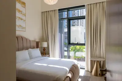 a bedroom with a bed and a large window at Luxury 2BR unit with speculator full road view in Dubai