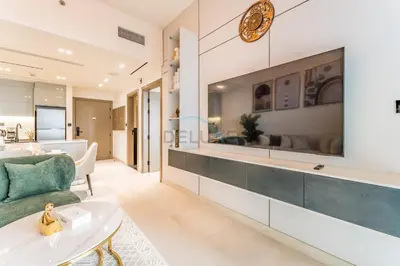 a living room with a large tv on the wall at Spacious Balcony Overlooking the Burj Khalifa and City Skyline, Near Bus Station, Quick Drive from Downtown Top Attractions, Binghatti Canal, Business Bay by Deluxe Holiday Homes in Dubai