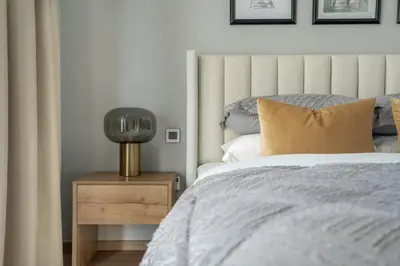 a bedroom with a bed and a lamp on a night stand at GuestReady - Stylish retreat near Dubai Mall in Dubai