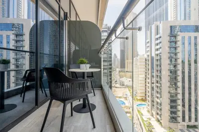 a balcony with a table and chairs and a view of a city at GuestReady - Stylish retreat near Dubai Mall in Dubai