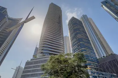 two tall buildings in a city with a palm tree at GuestReady - Stylish retreat near Dubai Mall in Dubai