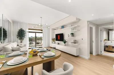 a dining room and living room with a table and chairs at Modern and family friendly 1 bed in Dubai