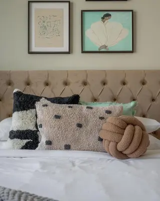 a bedroom with a bed with pillows on it at GuestReady - Sunny Retreat near Dubai Frame in Dubai