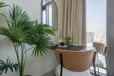 a dining room with a table and some plants at GuestReady - Sunny Retreat near Dubai Frame in Dubai