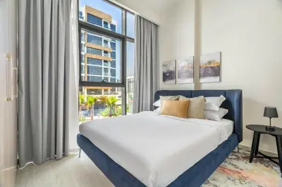 a bedroom with a large bed and a large window at GuestReady - Contemporary elegance in Dubai in Dubai