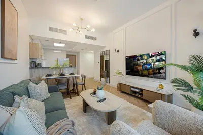 a living room with a couch and a table at Marina Waterfront Bliss - Steps from Promenade in Dubai