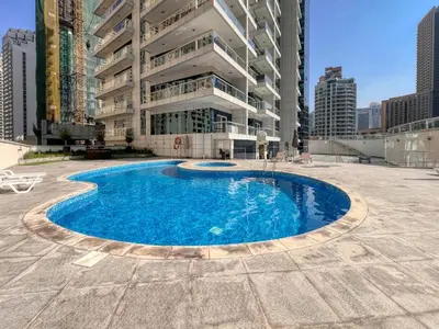 a large swimming pool in front of a building at Marina Waterfront Bliss - Steps from Promenade in Dubai