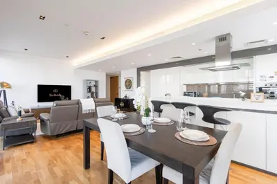 a dining room and living room with a table and chairs at Bluewaters 2B Iconic Ain Dubai and Sea View in Dubai