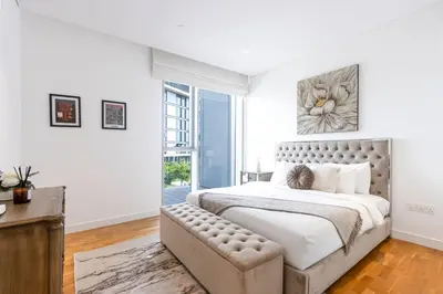 a white bedroom with a large bed and a window at Bluewaters 2B Iconic Ain Dubai and Sea View in Dubai