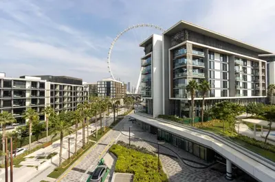 a rendering of a building with a ferris wheel in the background at Bluewaters 2B Iconic Ain Dubai and Sea View in Dubai