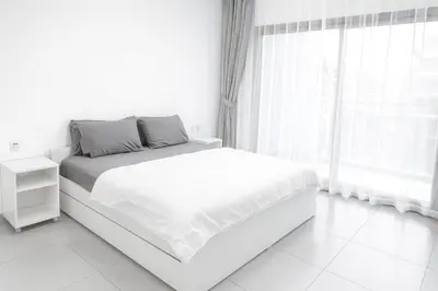 a white bedroom with a bed and a window at New Large 2BR Apt Sleeps 10 Adults with Pool Gym Parking and Wifi in Dubai