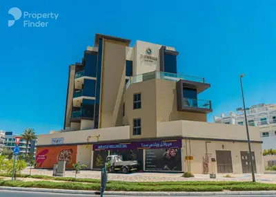 a large building with a truck parked in front of it at New Large 2BR Apt Sleeps 10 Adults with Pool Gym Parking and Wifi in Dubai