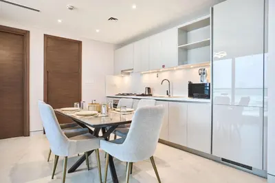 a dining room with a table and chairs in a kitchen at STAY BY LATINEM Luxury 1BR Holiday Home CVG 604 Near Downtown in Dubai