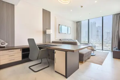 an office with a desk with a chair and a couch at STAY BY LATINEM Luxury 1BR Holiday Home CVG 604 Near Downtown in Dubai
